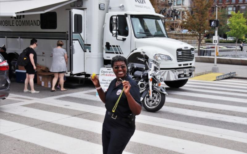 GCRTA Transit Police officer in front of the Mobile Command Vehicle.