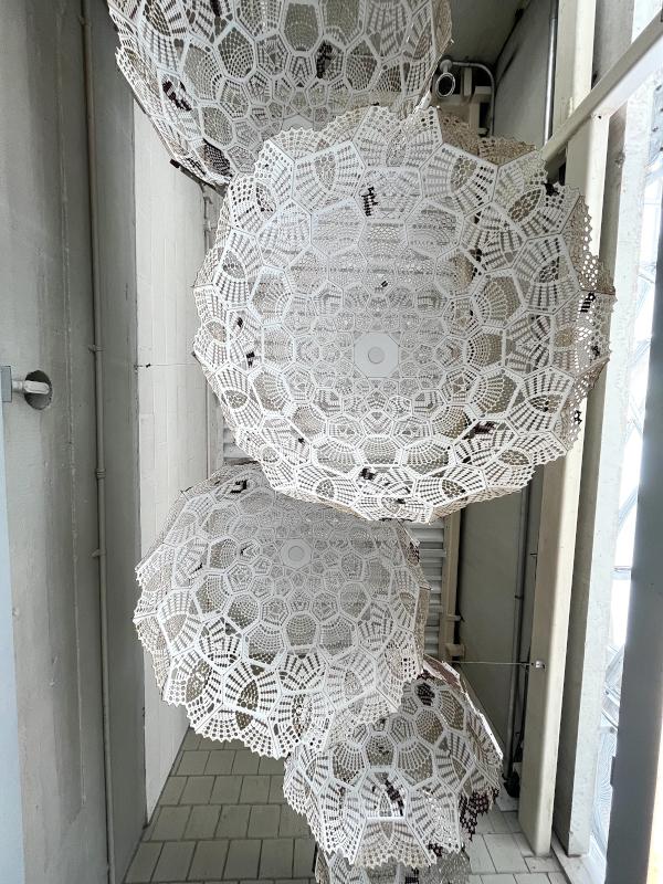 Inspired by a traditional crochet pattern, and fabricated in water jet steel. The artists loved the idea of starting something intimate and making it public. This suspended sculpture won a national competition. 