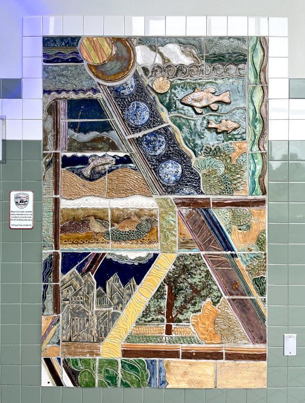 This ceramic tile mural represents different components of the Northeast Ohio ecosystem and the values of the EcoVillage district.