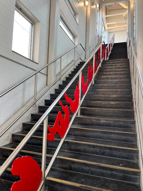 These red figures are completed in a series to portray motion and movement associated with public transit and in particular, train travel.