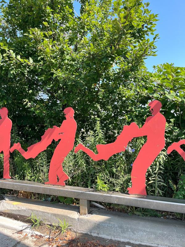 These red figures are completed in a series to portray motion and movement associated with public transit and in particular, train travel.