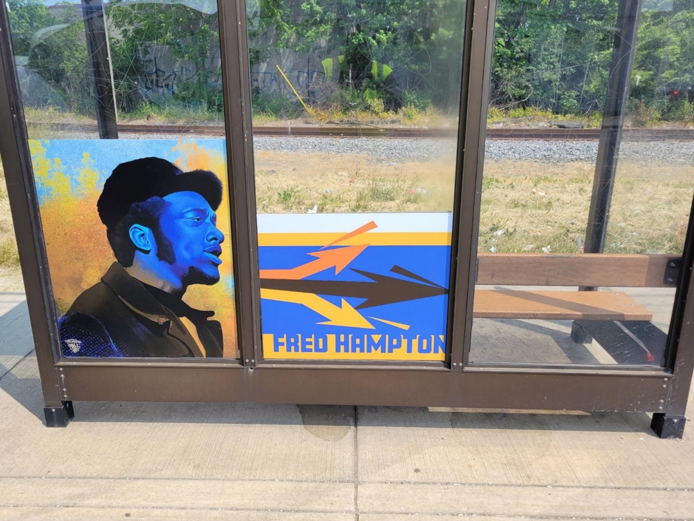 Fred Hampton Bus Shelter Wrap on Miles Ave. at E.131 St., Westbound.