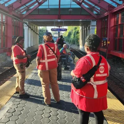 Transit Ambassadors Helping People on Buses, Trains, and in Stations
