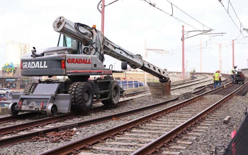 Construction workers working on the railroad track for the Waterfront Line.